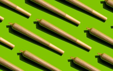 A variety of rolling paper packs, including joint papers and cigarette paper, displayed with high-quality botanical material.